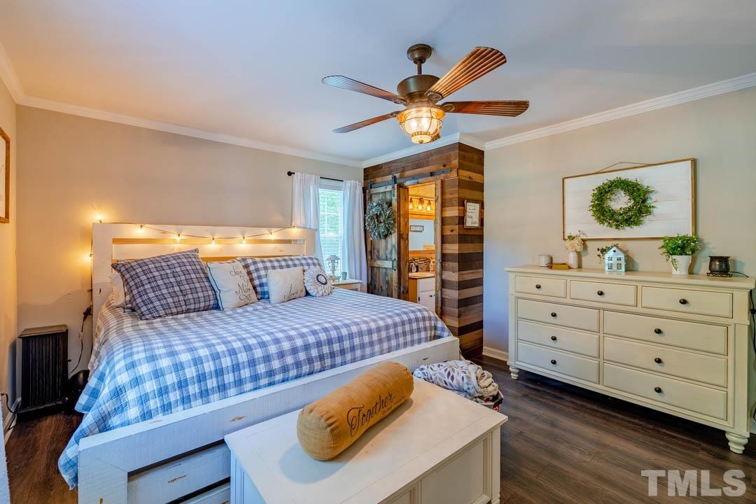 9622 Sawyer Road Rougemont, NC 27572 - Photo 21 of 34 a bedroom with a bed and a chandelier