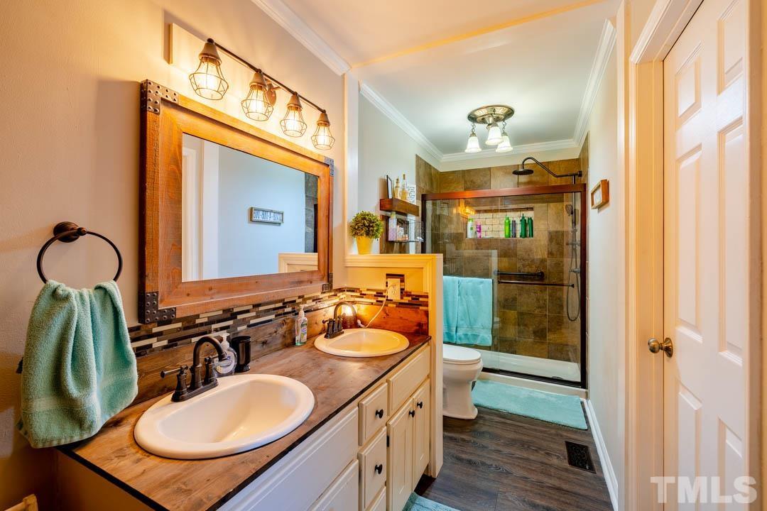 9622 Sawyer Road Rougemont, NC 27572 - Photo 22 of 34 a bathroom with a sink double vanity and a mirror