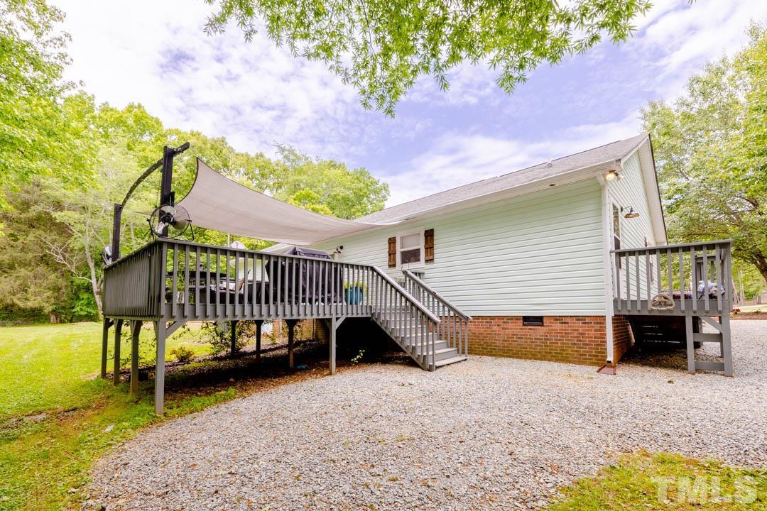 9622 Sawyer Road Rougemont, NC 27572 - Photo 29 of 34 a view of a house with a yard balcony furniture and a slide
