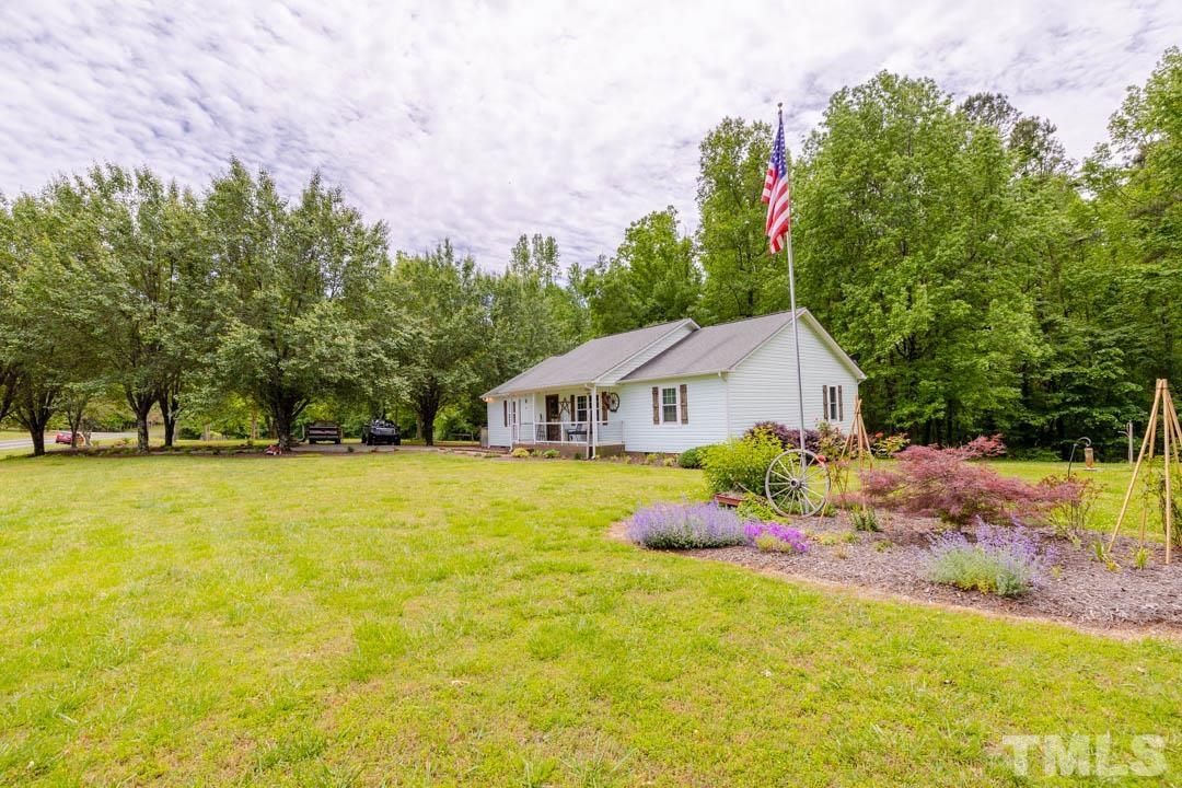 9622 Sawyer Road Rougemont, NC 27572 - Photo 3 of 34 a front view of a house with a yard and trees