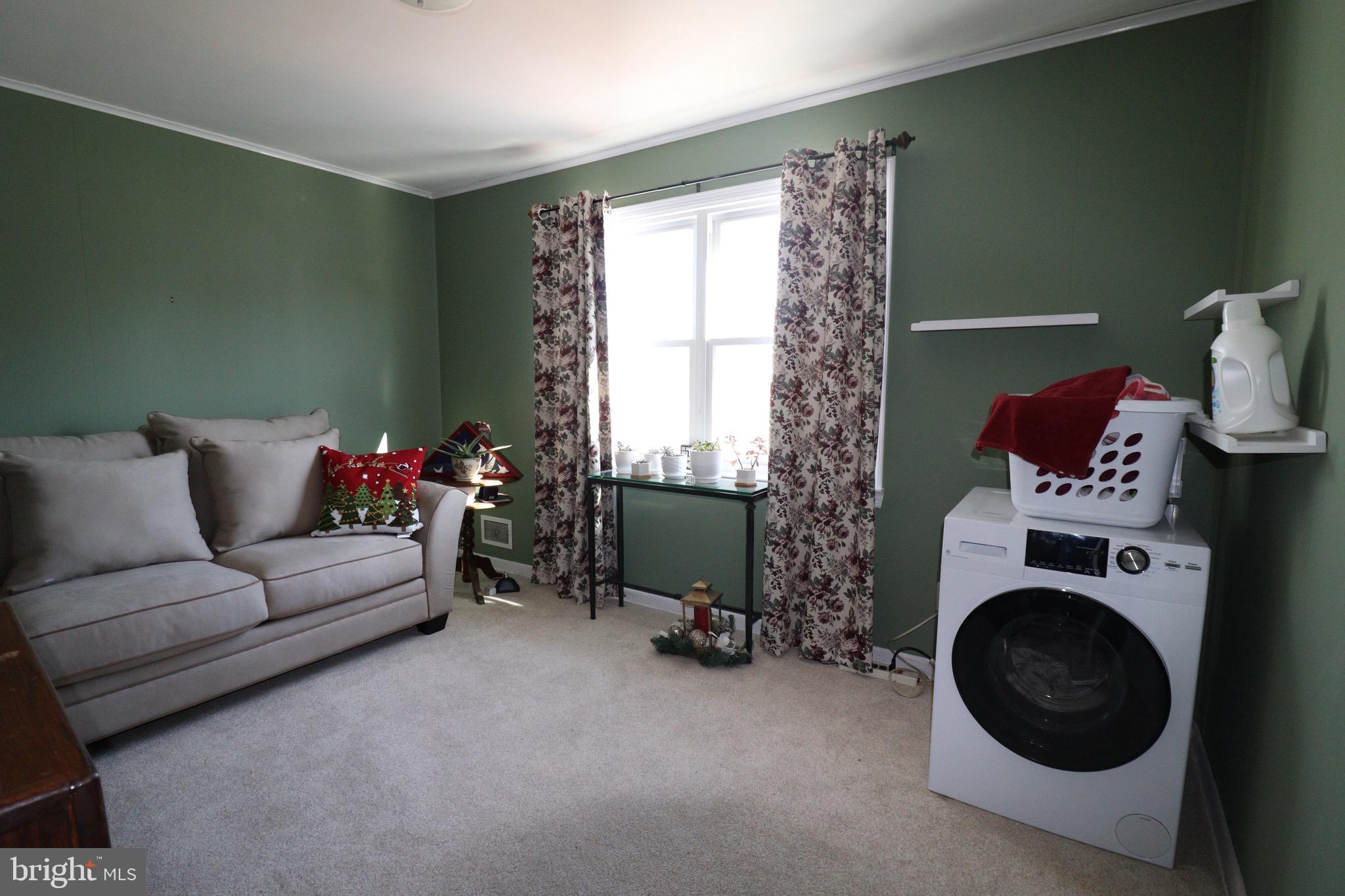 56 Sherbrooke Road Trenton, NJ 08638 - Photo 11 of 31 a living room with furniture and a fireplace