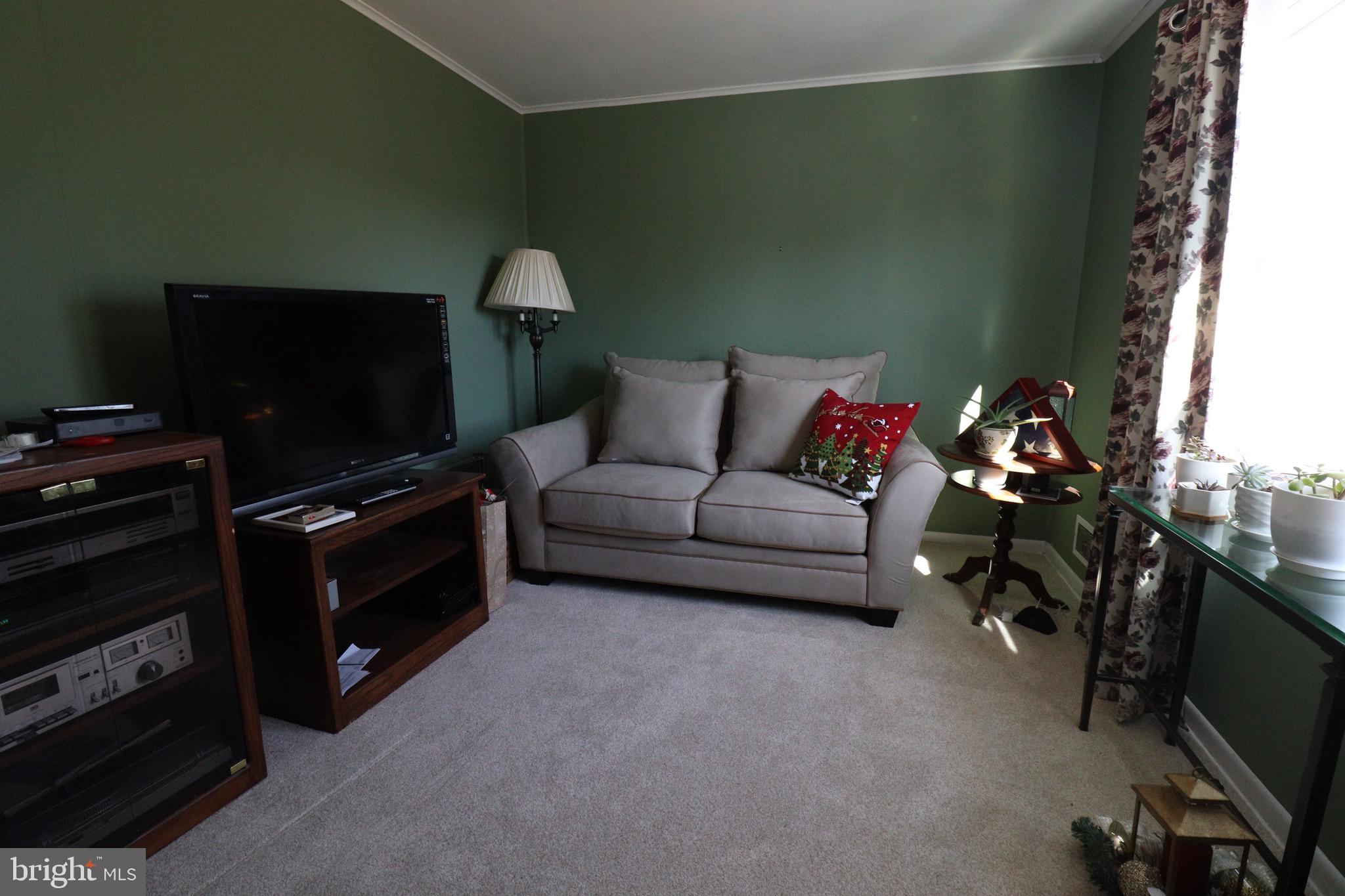 56 Sherbrooke Road Trenton, NJ 08638 - Photo 12 of 31 a living room with furniture and a flat screen tv