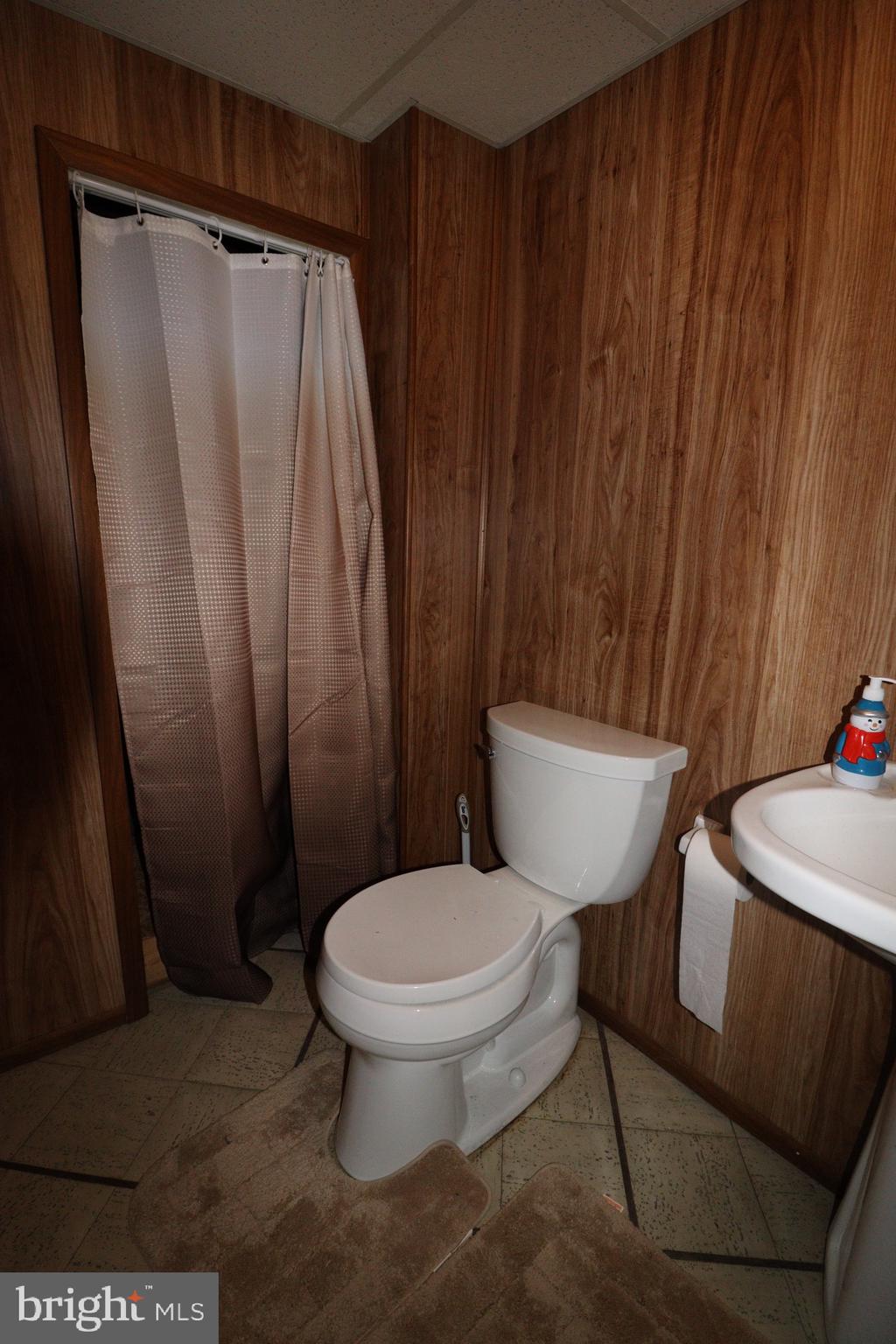 56 Sherbrooke Road Trenton, NJ 08638 - Photo 14 of 31 a white toilet sitting next to a shower curtain