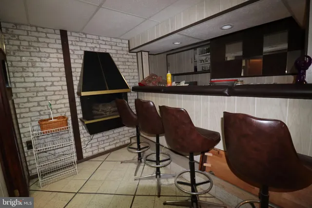 a kitchen with a table chairs and a refrigerator