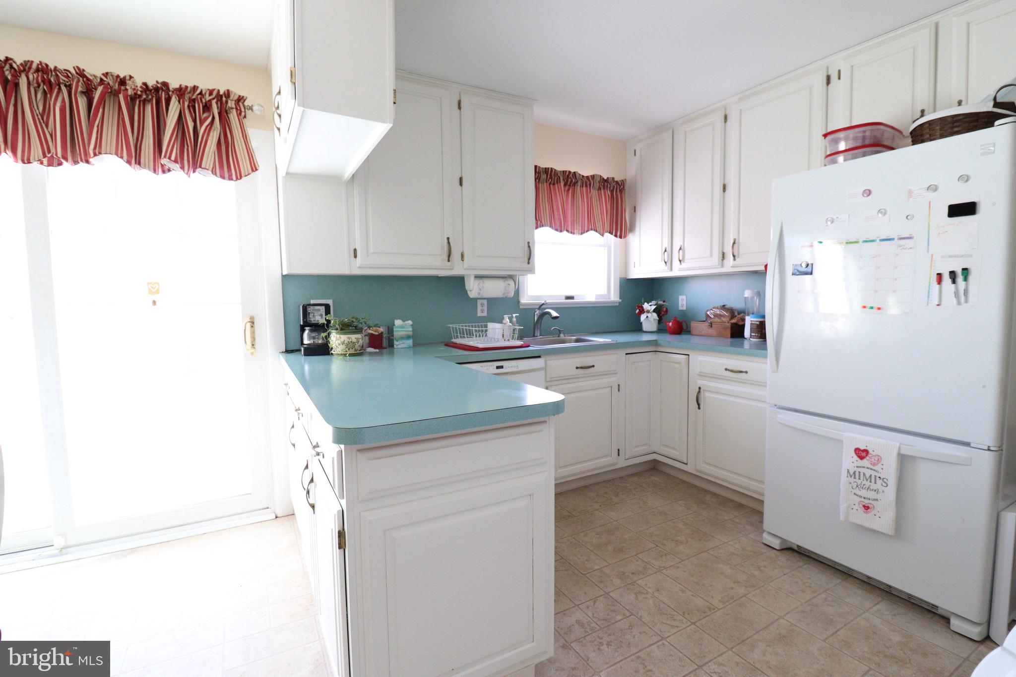 56 Sherbrooke Road Trenton, NJ 08638 - Photo 18 of 31 a kitchen with a sink a refrigerator and a stove