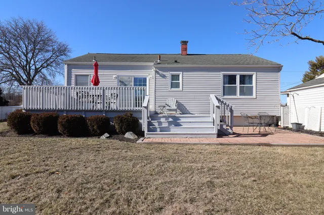 a view of a house with a yard and sitting area