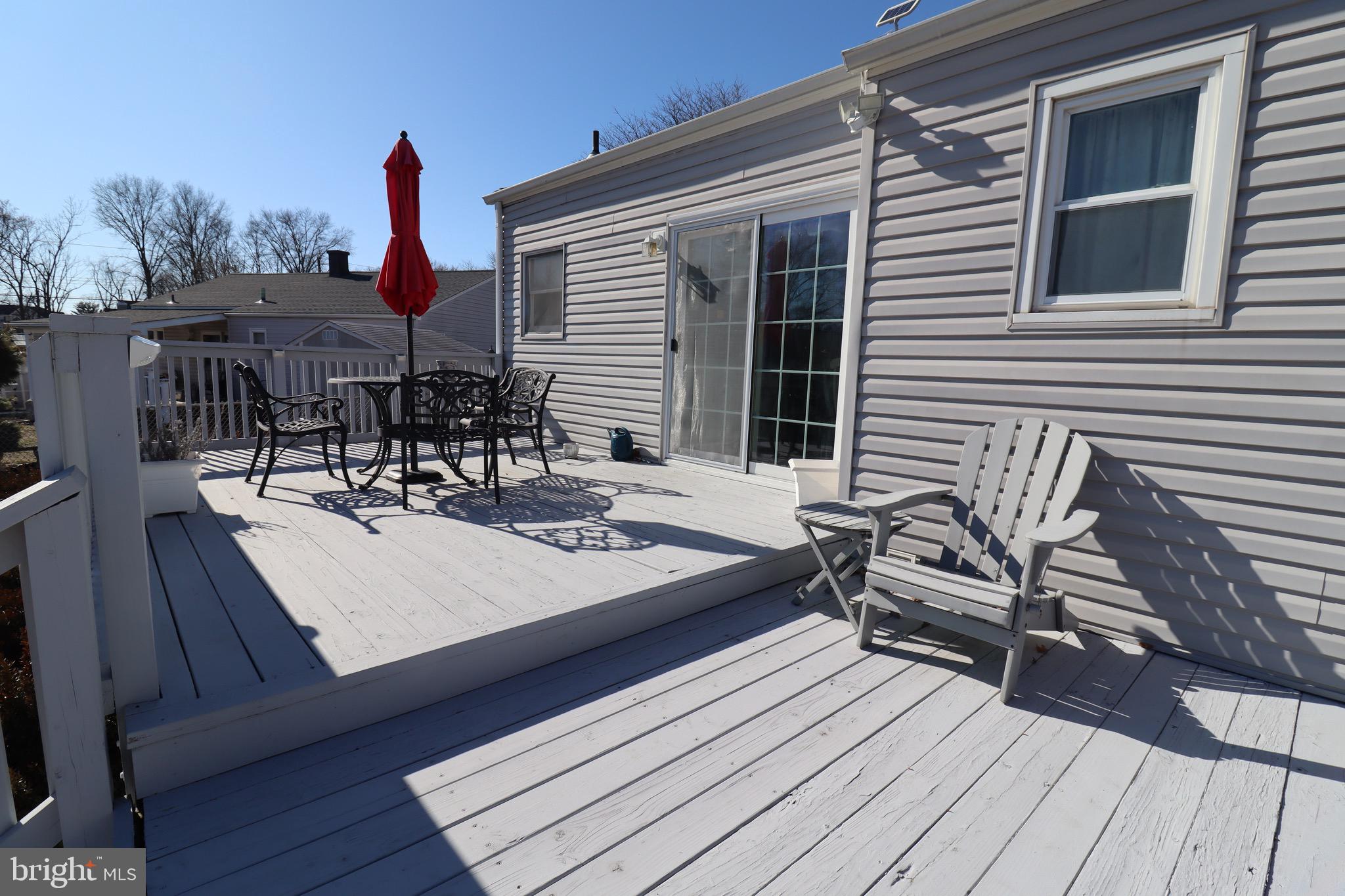 56 Sherbrooke Road Trenton, NJ 08638 - Photo 28 of 31 a view of a patio with table and chairs with wooden floor and fence