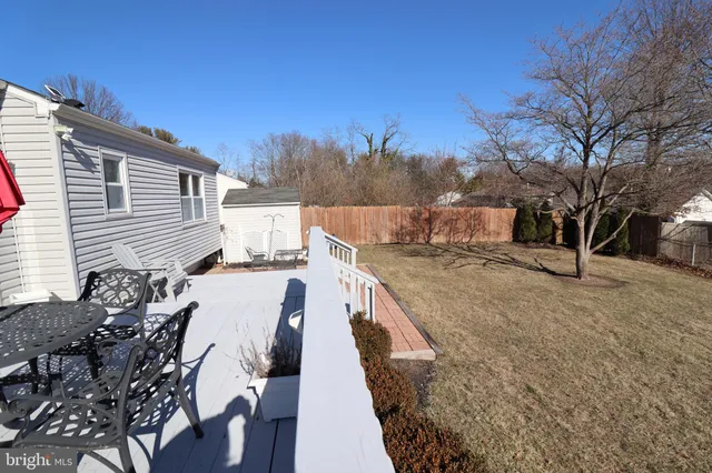 a view of a house with backyard and trees