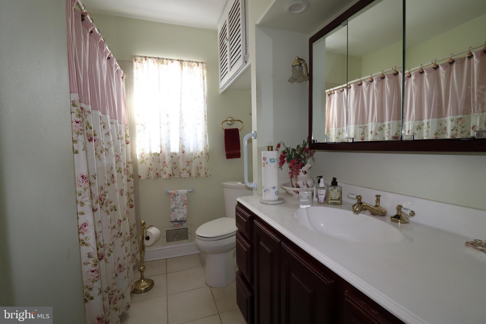 56 Sherbrooke Road Trenton, NJ 08638 - Photo 6 of 31 a bathroom with a sink and a mirror