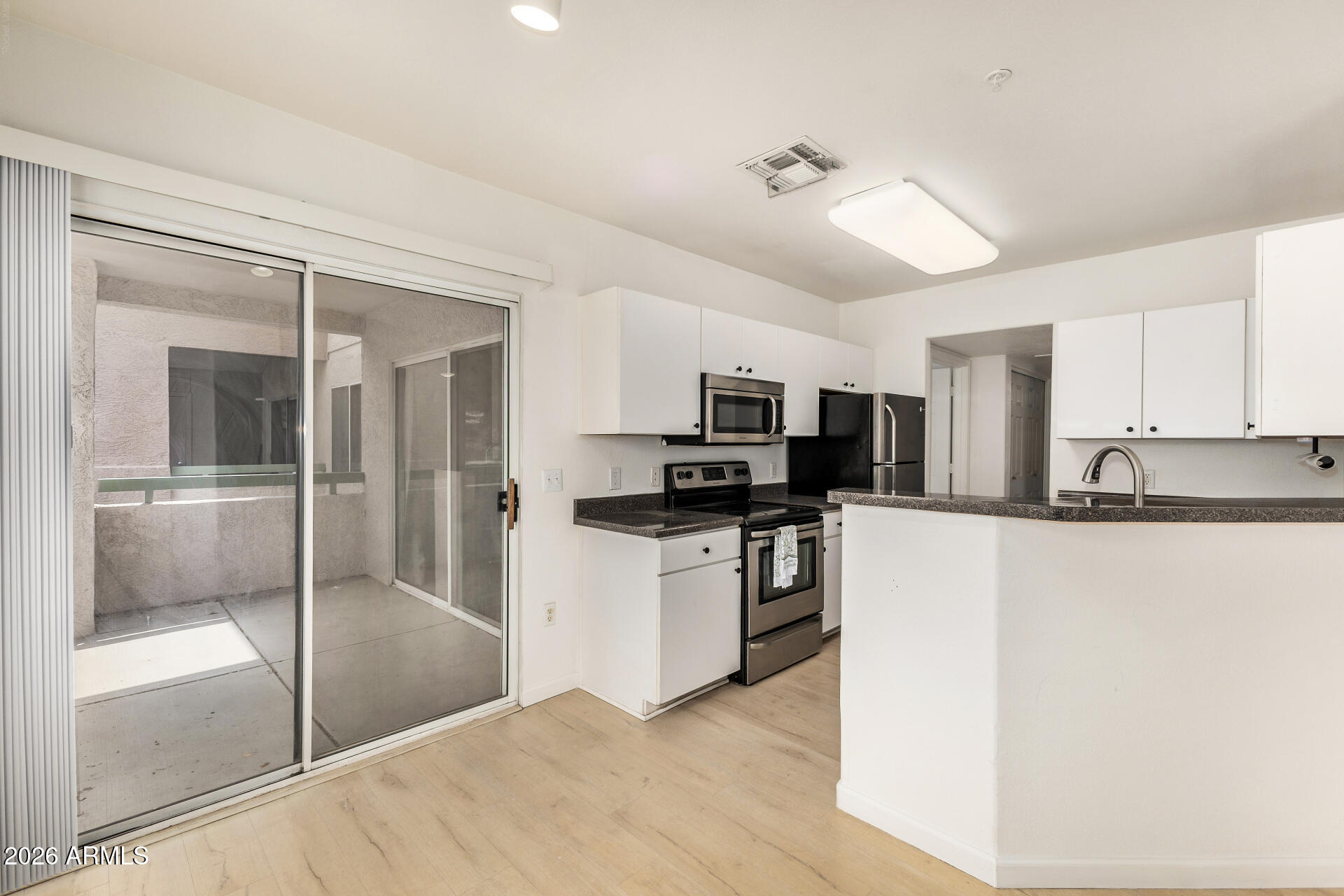 1295 North Ash Street, Unit 828 Gilbert, AZ 85233 - Photo 2 of 43 a kitchen with stainless steel appliances a refrigerator sink and microwave