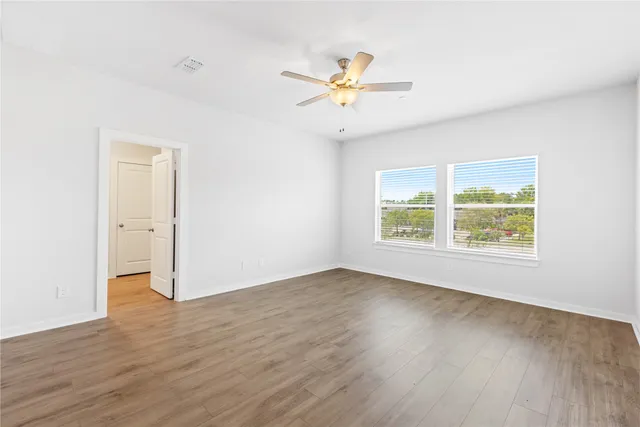 a spacious bathroom with a double vanity sink toilet and a mirror