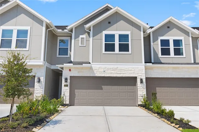 a front view of a house with garage