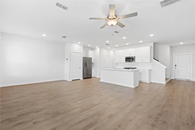 a kitchen with a sink a stove a refrigerator and a stove