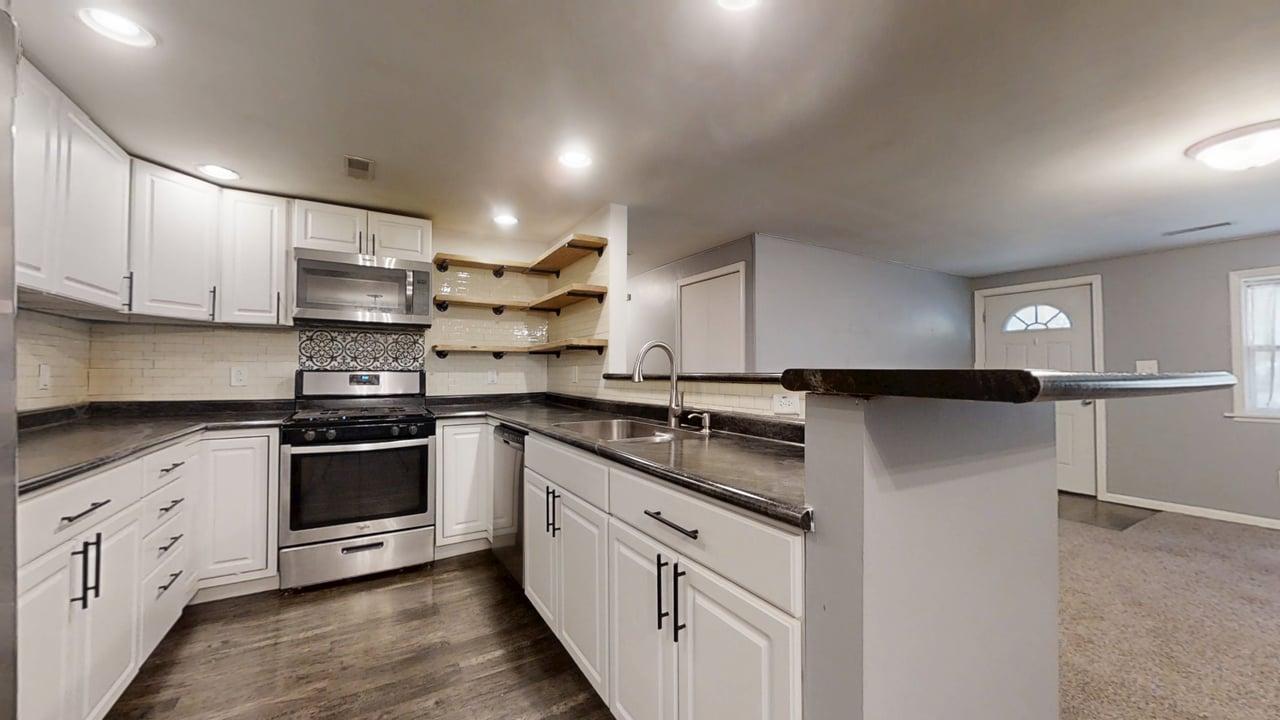 1410 South Mattis Avenue Champaign, IL 61821 - Photo 9 of 27 a kitchen with granite countertop white cabinets and stainless steel appliances