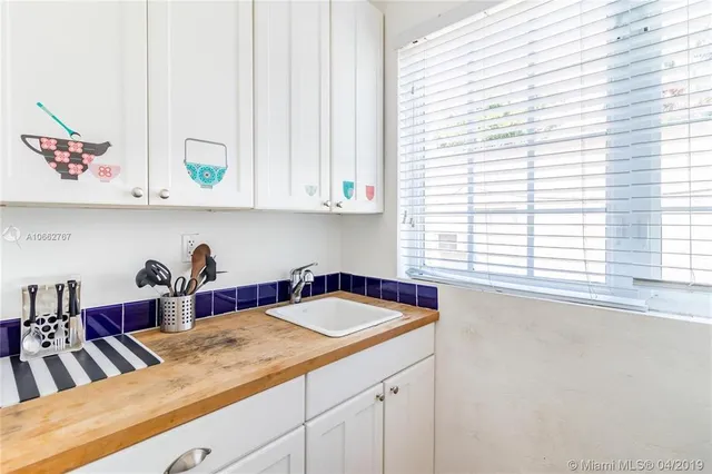 a kitchen with a sink and a window