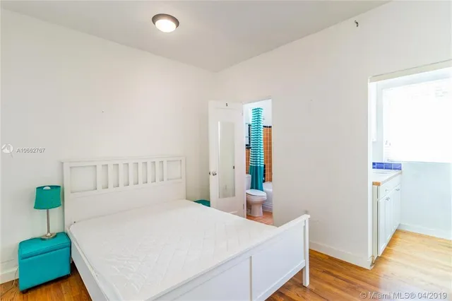 a bedroom with a bed and a table