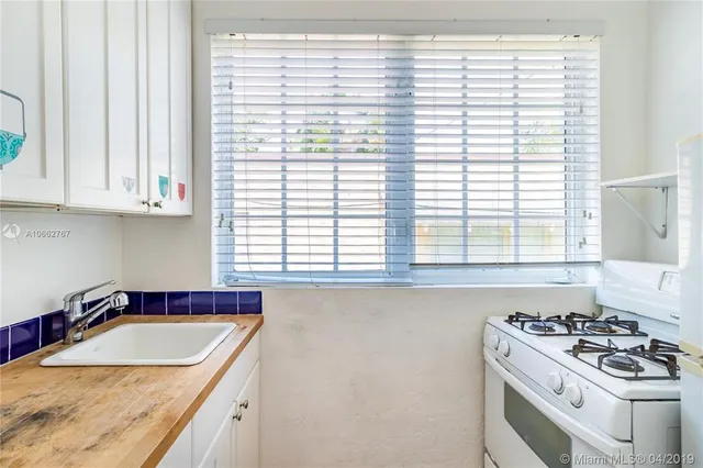 a kitchen with granite countertop a sink and a window