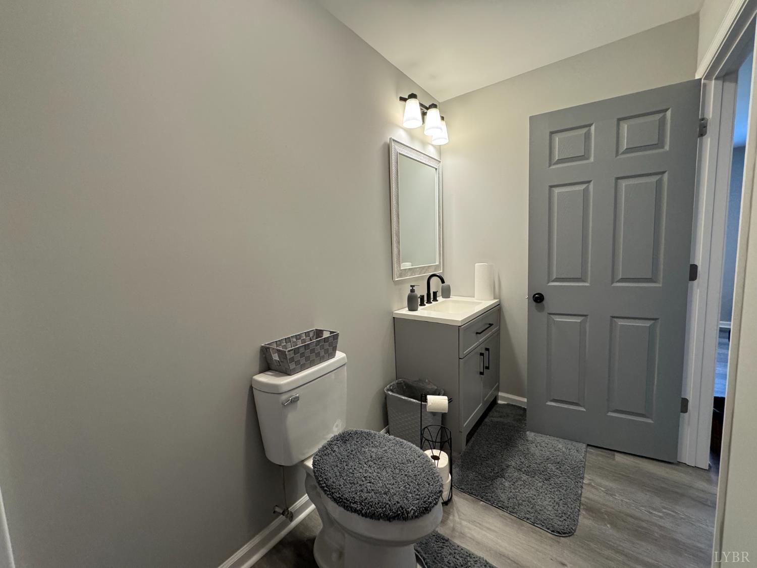 a bathroom with a toilet a sink and mirror