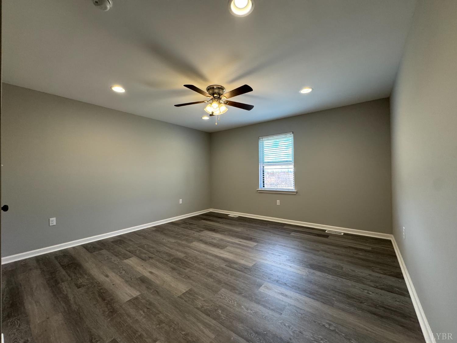 3941 Promise Land Road Appomattox, VA 24522 - Photo 11 of 21 an empty room with wooden floor and a ceiling fan