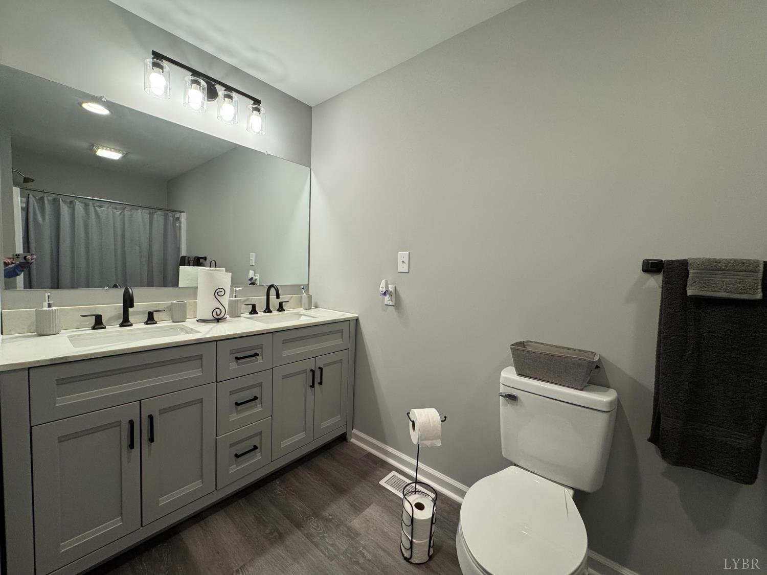 3941 Promise Land Road Appomattox, VA 24522 - Photo 9 of 21 a bathroom with a toilet sink double vanity and mirror