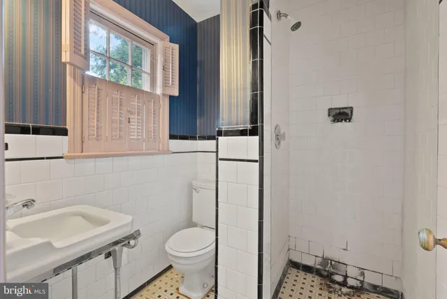 a bathroom with a sink a toilet and tub