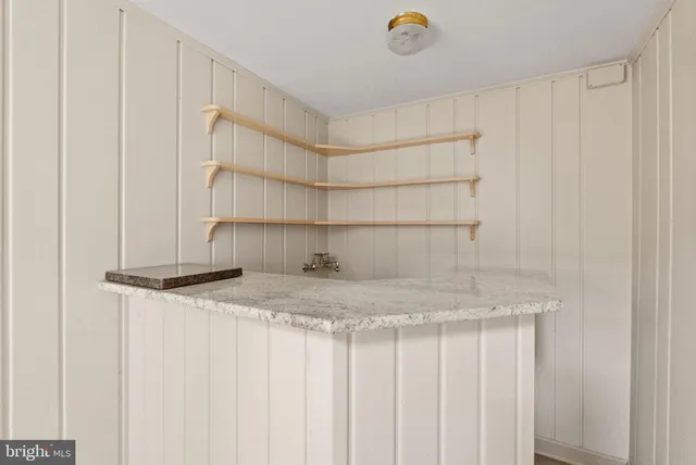 a view of an empty room with a fireplace and a window