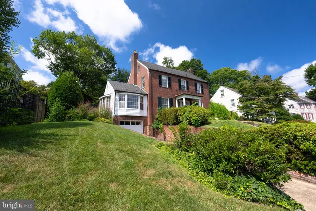 a view of a house with yard and a garden