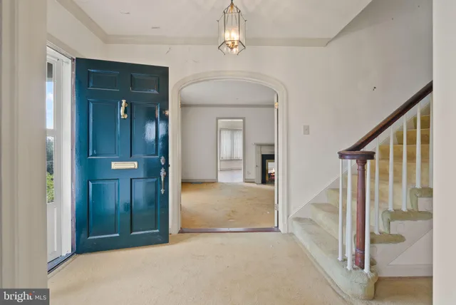 an empty room with wooden floor mirror and windows