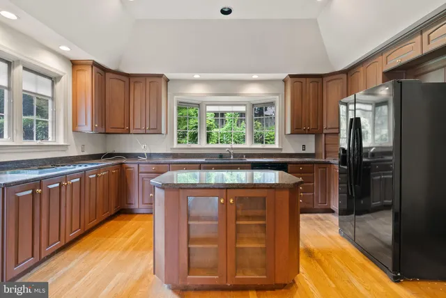 a kitchen with stainless steel appliances granite countertop wooden cabinets a sink and a stove
