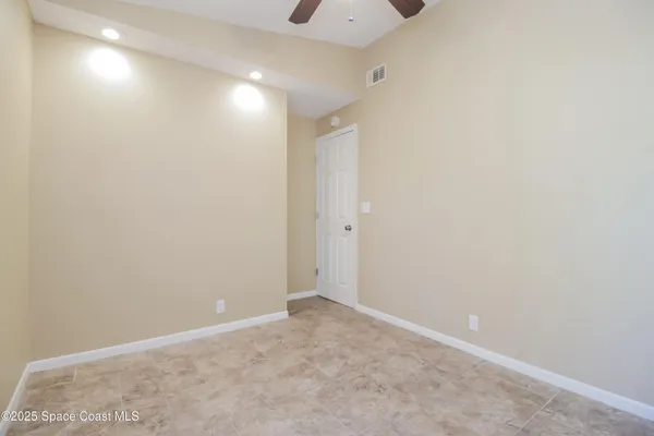 a bathroom with a granite countertop sink mirror vanity and toilet