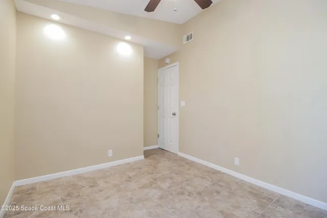a bathroom with a granite countertop sink mirror vanity and toilet