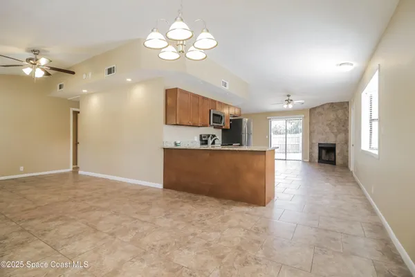 a view of kitchen and kitchen with granite countertop cabinets a fireplace