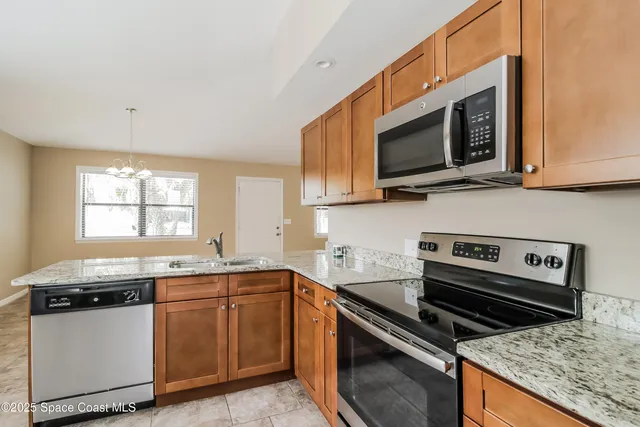 a kitchen with stainless steel appliances a sink stove and microwave