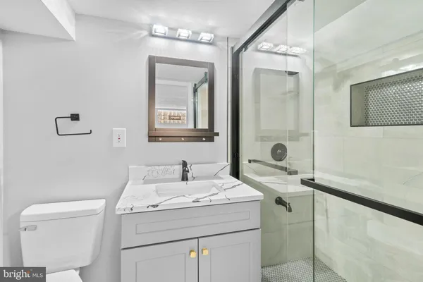 a bathroom with a sink toilet and shower