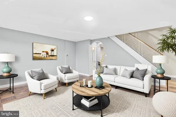 a living room with furniture and a potted plant on table
