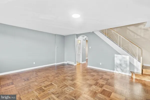 a view of an empty room with wooden floor