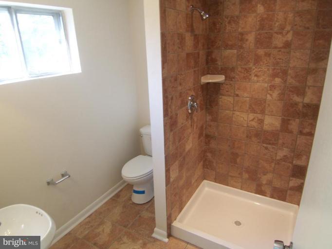 7909 Hart Road Fort Washington, MD 20744 - Photo 18 of 21 a bathroom with a toilet and a shower