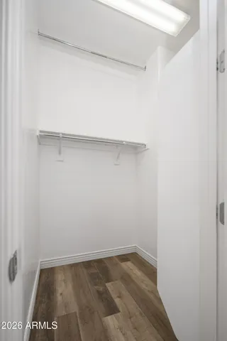 an empty room with a window and a ceiling fan