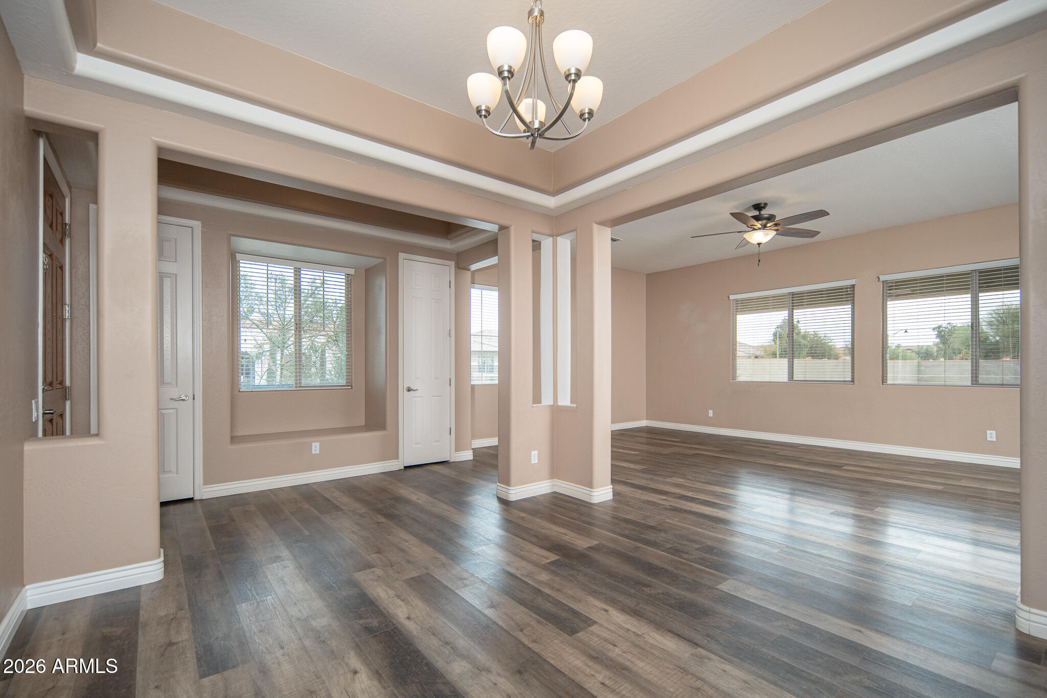 20377 West Shadow Street Buckeye, AZ 85396 - Photo 4 of 37 a view of an empty room with wooden floor and a window