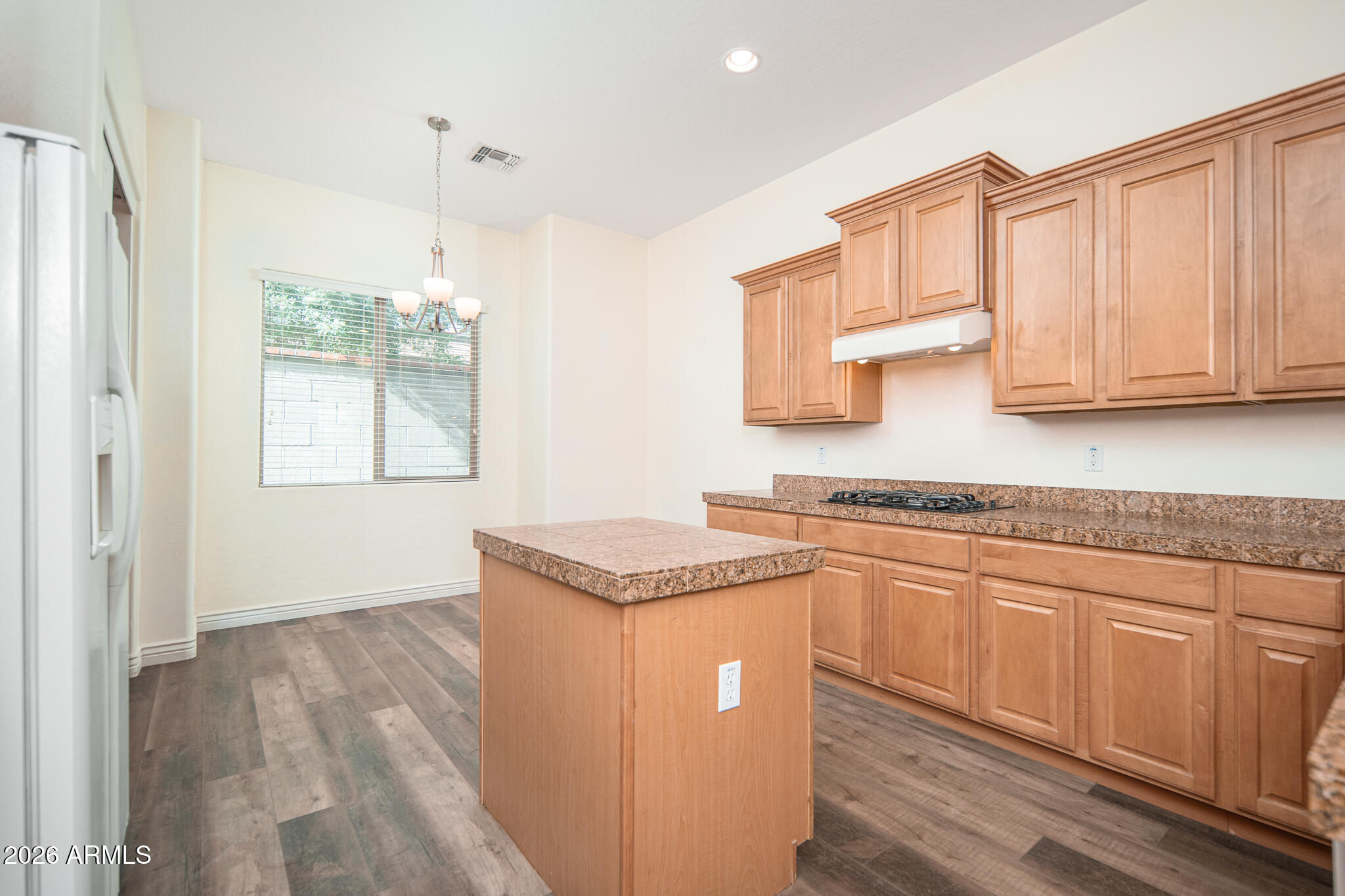 20377 West Shadow Street Buckeye, AZ 85396 - Photo 5 of 37 a kitchen with stainless steel appliances granite countertop a sink a stove and a wooden cabinets