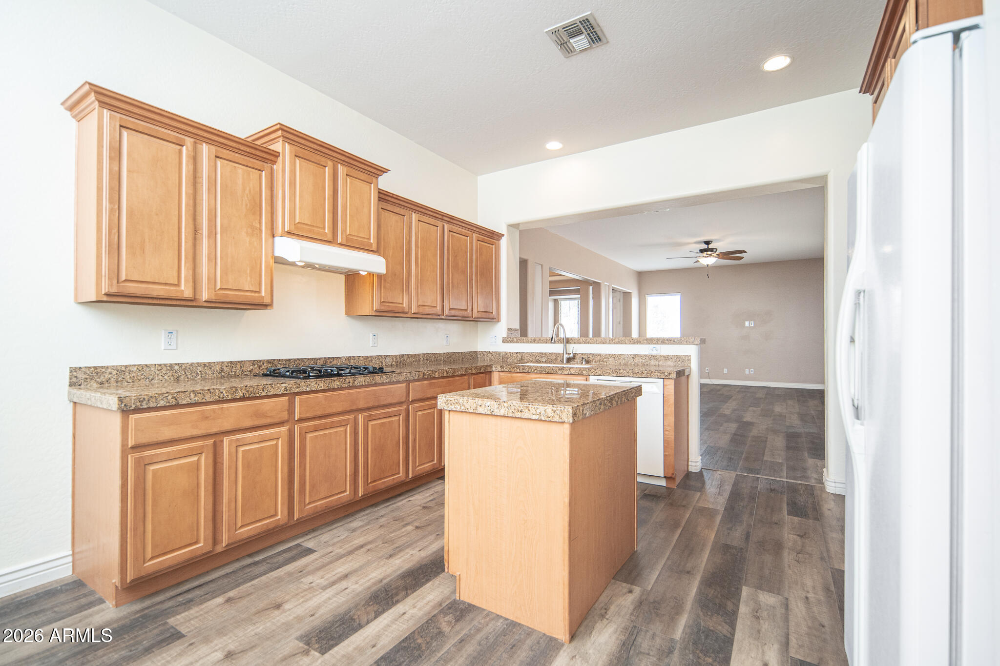 20377 West Shadow Street Buckeye, AZ 85396 - Photo 7 of 37 a kitchen with a stove a sink and a refrigerator