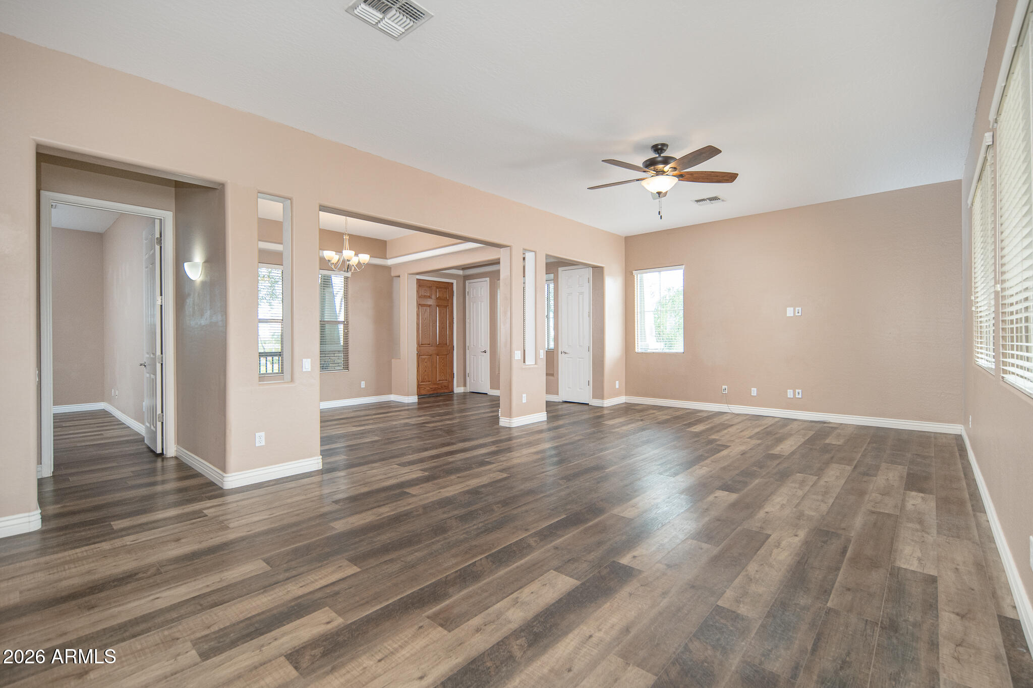 20377 West Shadow Street Buckeye, AZ 85396 - Photo 9 of 37 a view of an empty room with window and wooden floor