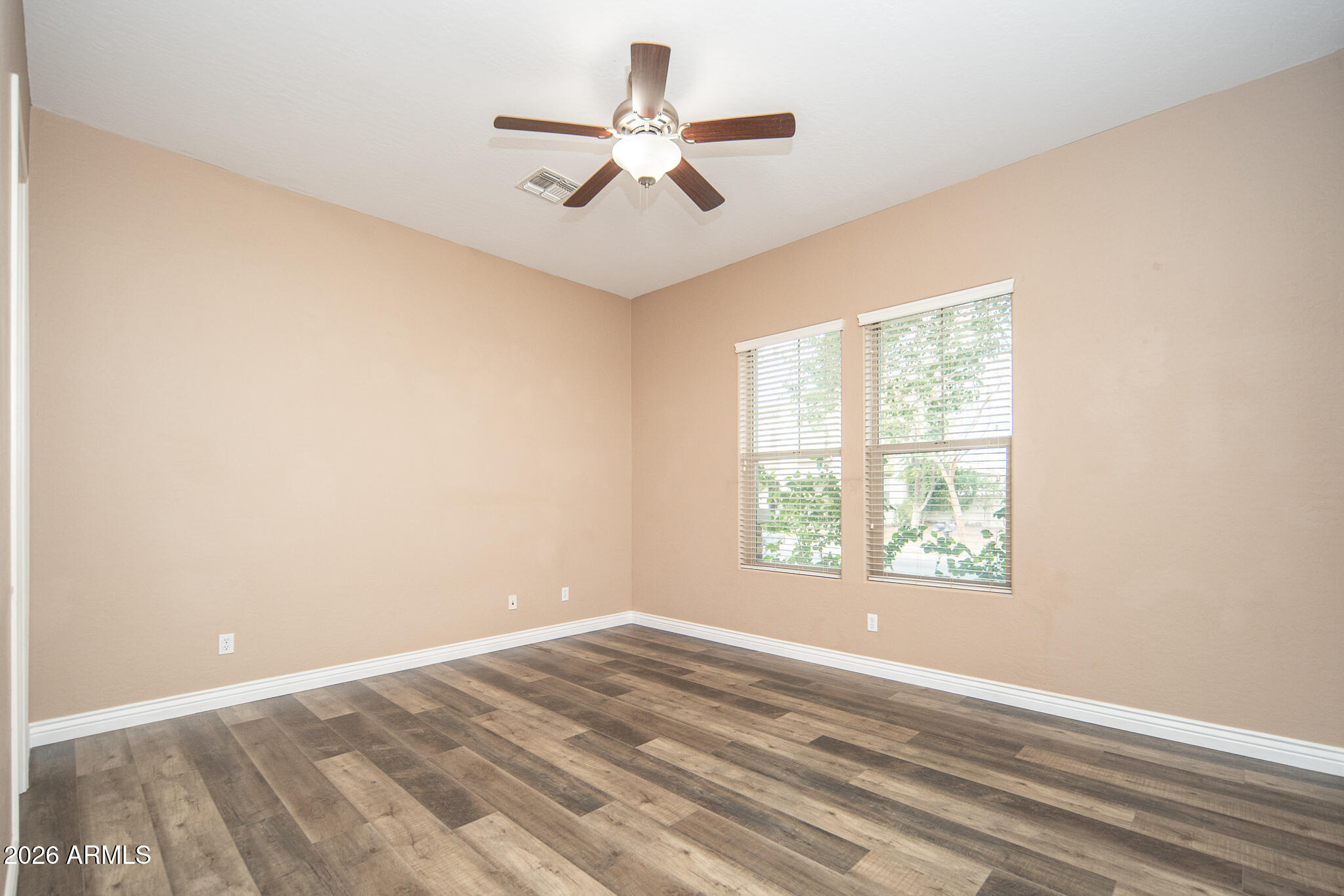 20377 West Shadow Street Buckeye, AZ 85396 - Photo 10 of 37 an empty room with a window and a fan
