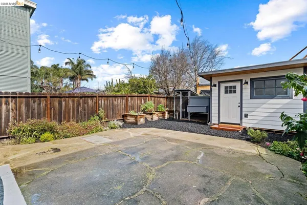 a view of a house with backyard and sitting area