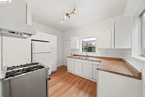 a kitchen with a sink stove and refrigerator