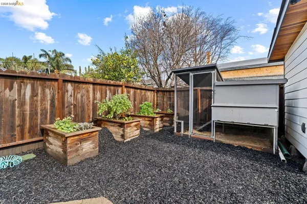 a backyard of a house with barbeque oven and outdoor seating