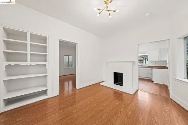 a room with wooden floor and fireplace