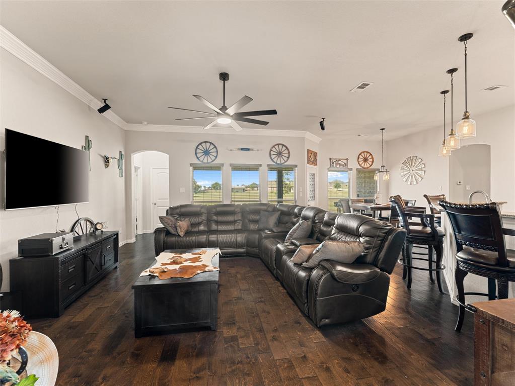 109 Highland Hills Boulevard Decatur, TX 76234 - Photo 11 of 36 a living room with furniture kitchen view and a flat screen tv