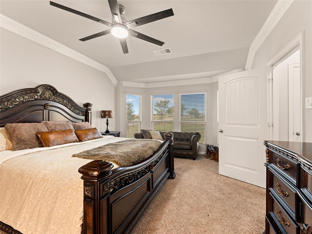 109 Highland Hills Boulevard Decatur, TX 76234 - Photo 19 of 36 a bedroom with a bed and a chandelier