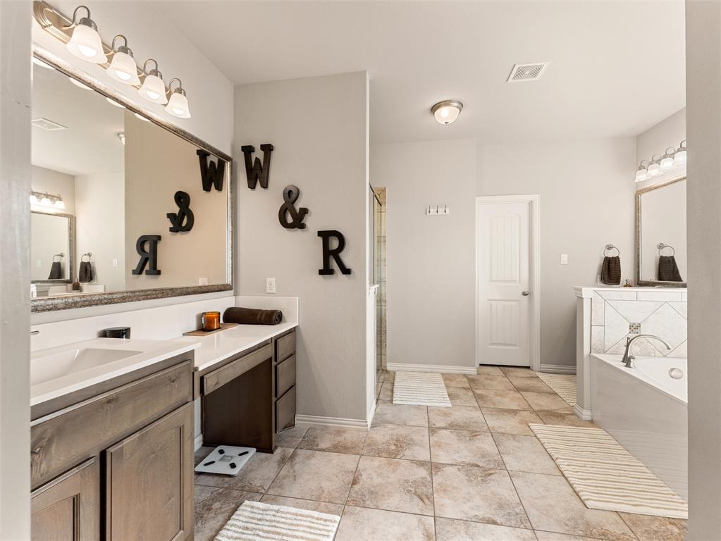 109 Highland Hills Boulevard Decatur, TX 76234 - Photo 20 of 36 a spacious bathroom with a sink a mirror and a shower